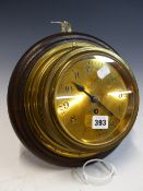 A BRASS CASED SHIPS CLOCK RETAILED BY BARKERS OF KENSINGTON, THE BRASS FACE WITH ARABIC NUMERALS