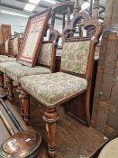 A SET OF SIX VICTORIAN CARVED OAK DINING CHAIRS.