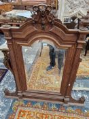 A FRENCH WALNUT OVER MANTLE MIRROR.