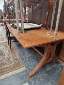 A LARGE IMPRESSIVE HARDWOOD DINING TABLE ON CARVED SPLAY LEG SUPPORTS.