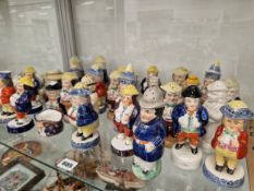 TWENTY EIGHT STAFFORDSHIRE AND OTHER POTTERY CASTERS IN THE FORM OF STANDING MEN