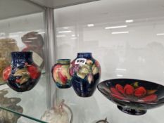 THREE MOORCROFT VASES AND FOOTED DISH DECORATED WITH GRAPES AND FLOWERS