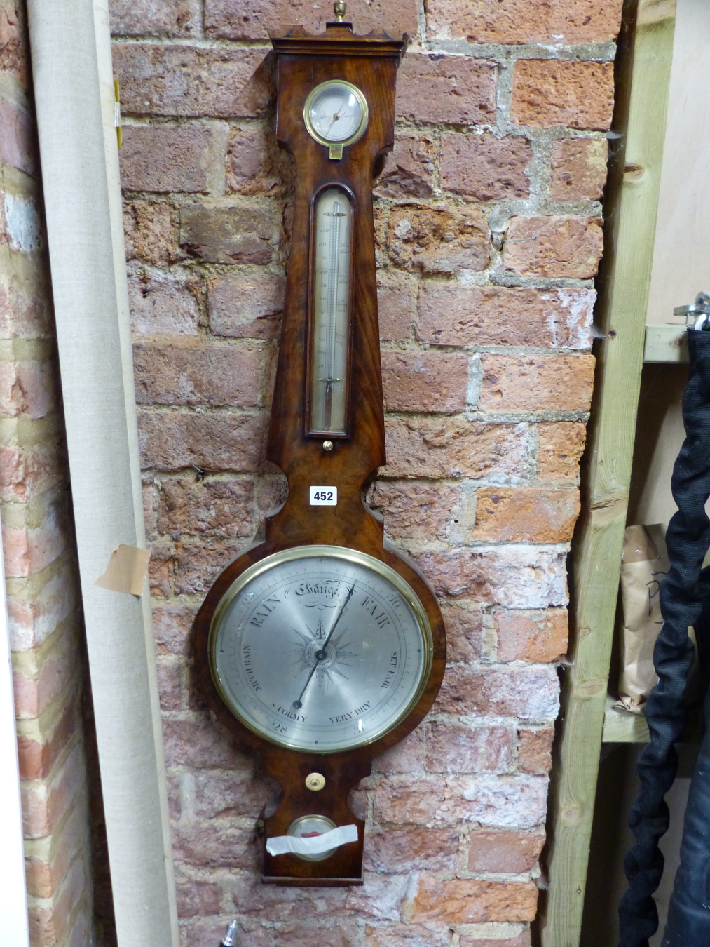 A CAPELLA MAHOGANY BANJO BAROMETER WITH AN ALCOHOL THERMOMETER ABOVE THE SILVERED DIAL, ADJUSTMENT
