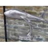 A 20th C. ALUMINIUM MODEL OF AN AEROPLANE RAISED ON A STAND WITH AN OVAL FOOT. W 59cms.