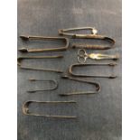 EIGHT SILVER SUGAR TONGS TOGETHER WITH A PAIR OF SILVER SUGAR SCISSORS, 289.8Gms.
