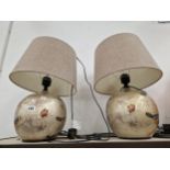 A PAIR OF SPHERICAL CERAMIC TABLE LAMPS DECORATED WITH BIRDS, BUTTERFLIES AND FLOWERS