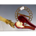 A BRUSH WITH A BRASS FOX HEAD HANDLE, A BRASS FRAME AND A CASED MEERSCHAUM PIPE CARVED WITH A HARE