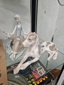 A LLADRO FIGURE OF A GIRL SEATED WITH HER BIRD TOGETHER WITH A LOMONOSOV RECLINING DOG