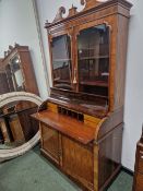 A REGENCY ROSEWOOD PIANO TOPPED BUREAU BOOKCASE.