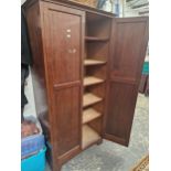 AN EDWARDIAN MAHOGANY HALL CUPBOARD WITH SHELVED INTERIOR