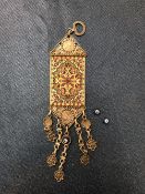 A MIDDLE EASTERN WHITE METAL AND MACHINE WOVEN SILK CHATELAINE