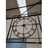 A LARGE ORNAMENTAL IRON WALL CLOCK