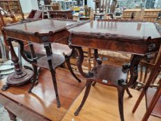 A PAIR OF MAHOGANY TWO TIER TABLES WITH CARVED DECORATION.