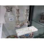 A PAIR OF HALLMARKED SILVER LOADED CANDLESTICKS, A SILVER MOUNTED DECANTER AND A SET OF SIX