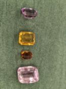 FOUR VARIOUS CUT STONES TO INCLUDE AMETHYST, KUNZITE, CITRINE AND PASTE.