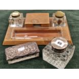 A HALLMARKED SILVER TOPPED INK WELL, A SILVER TOP ART NOUVEAU GLASS BOX AND A LEATHER DESK STAND.