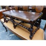 AN ANTIQUE MAHOGANY LONG STOOL.