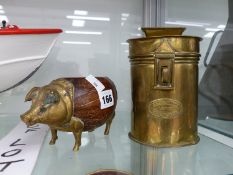 AN INTERESTING BRASS MOUNTED COCONUT BODIED PIG DISH, AND A VINTAGE BRASS MONEY BOX.