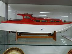 A VINTAGE MODEL BOAT ON STAND.