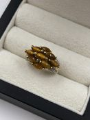 A HALLMARKED 9ct GOLD TIGERS EYE AND DIAMOND SET CLUSTER RING. FINGER SIZE K. WEIGHT 3.44grms.