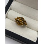 A HALLMARKED 9ct GOLD TIGERS EYE AND DIAMOND SET CLUSTER RING. FINGER SIZE K. WEIGHT 3.44grms.