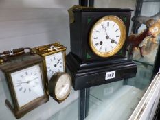 A VICTORIAN SLATE MANTLE CLOCK, TWO BRASS CARRIAGE CLOCKS AND A DRESSING TABLE CLOCK.