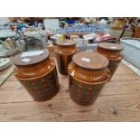 FOUR HORNSEA BRONTE PATTERN STORAGE JARS AND WOODEN COVERS
