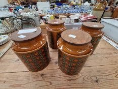FOUR HORNSEA BRONTE PATTERN STORAGE JARS AND WOODEN COVERS