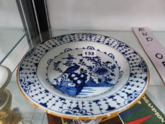 AN ANTIQUE BLUE AND WHITE DELFT PLATE.