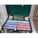 A CASED SET OF GAMING CHIPS.