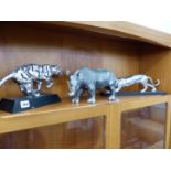 AN ALLOY MODEL OF A STALKING BIG CAT TOGETHER WITH A RHINO FIGURE AND A RUNNING TIGER FIGURE.