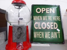 A VINTAGE STYLE ALLOY GUMBALL MACHINE AND A VINTAGE STYLE SIGN.