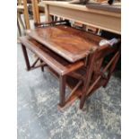 AN UNUSUAL NESTING TABLE WITH PULL OUT TRAY.