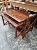 AN UNUSUAL NESTING TABLE WITH PULL OUT TRAY.