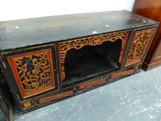 AN ORIENTAL CARVED AND PAINTED LOW SIDE CABINET.