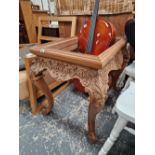 A CARVED WALNUT CABINET STAND.