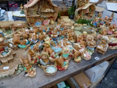 A VERY LARGE COLLECTION OF PENDELFIN RABBITS AND FOUR STANDS/ COTTAGES.