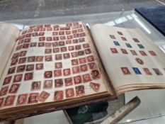TWO STAMP ALBUMS CONTAINING A LARGE NUMBER OF GB PENNY REDS AND NUMEROUS OTHER GB AND WORLD STAMPS.