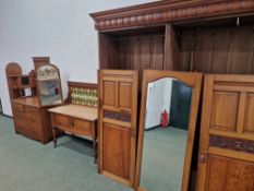 A LATE VICTORIAN BEDROOM SUITE OF TRIPLE DOOR WARDROBE, TRIPLE MIRROR BACK DRESSING CHEST AND A