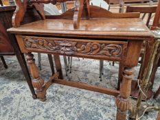 A CARVED OAK HALL TABLE.