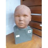 A WELL SCULPTED TERRACOTTA PORTRAIT BUST OF A CHILD ON STONE PLINTH. SIGNED INDISTINCTLY AND