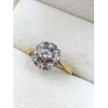 AN ANTIQUE 18ct GOLD AND PLATINUM DIAMOND CLUSTER RING. THE CENTRAL DIAMOND MEASURING 4.5 X 2.5mm,