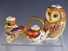 A ROYAL CROWN DERBY OWL PAPERWEIGHT TOGETHER WITH A MINIATURE WHEELBARROW, TEAPOT, AND MILK CHURN.
