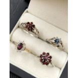 A SILVER AND 9ct GOLD STONE SET CLUSTER DRESS RING, TOGETHER WITH A THREE FURTHER SILVER CLUSTER