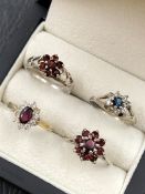 A SILVER AND 9ct GOLD STONE SET CLUSTER DRESS RING, TOGETHER WITH A THREE FURTHER SILVER CLUSTER