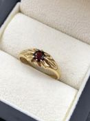 A 9ct HALLMARKED GOLD GARNET GYPSY SET RING. FINGER SIZE S. WEIGHT 2.28grms.