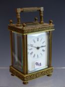 AN EARLY 20TH CENTURY BRASS CASED CARRIAGE CLOCK WITH WHITE ENAMEL DIAL.