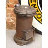 AN ANTIQUE CAST IRON TORTOISE STOVE FOR A SHEPHERDS HUT OR ROMANY WAGON.