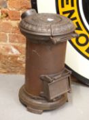 AN ANTIQUE CAST IRON TORTOISE STOVE FOR A SHEPHERDS HUT OR ROMANY WAGON.