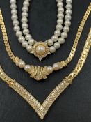 THREE VINTAGE CHRISTIAN DIOR NECKLACES. THE GOLD PLATED EXAMPLES LENGTH 41cms AND 47cms EACH, THE